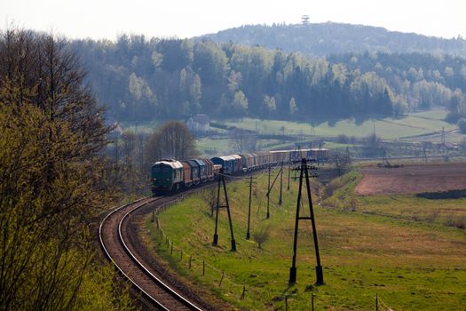 Freight train passing the hilly landscape

