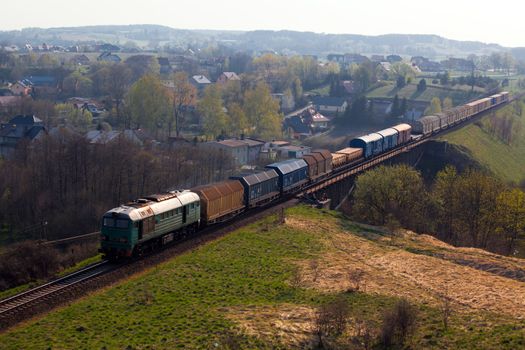 Freight train passing the hilly landscape
