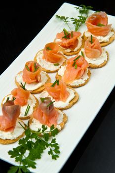 Canape with Salmon on white dish