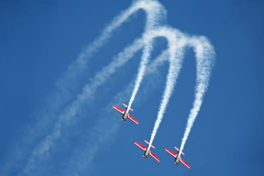 three airplanes Extra EA-300 on airshow