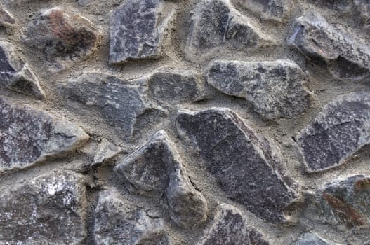 Fragment of gray stone wall surface