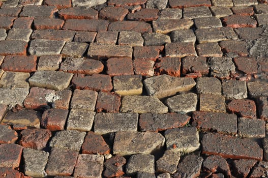 Fragment of rough red brick pavement surface