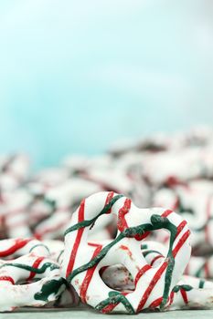 Yogurt covered pretzels with Christmas candy cane stripes. Room for text.