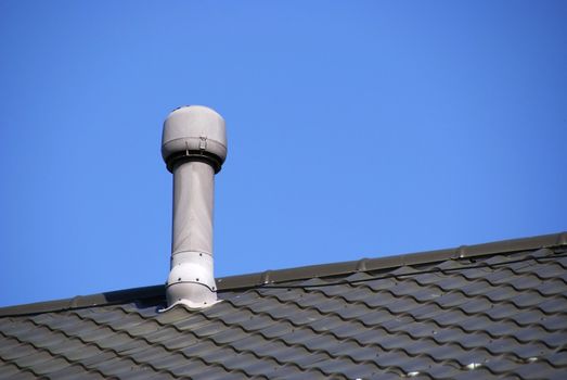 Pipe of ventilation are located on a roof of a residential building