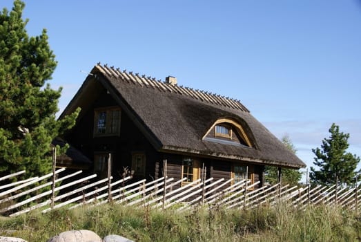 The wooden house close up and the blue sky