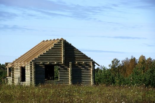 Construction of a wooden house with countryside