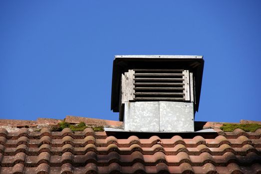 Ventilation pipe is located near a wall of glass