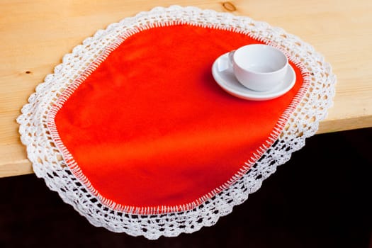 A coffee cup on an orange napkin
