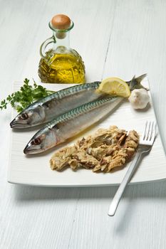 mackerel fiillet with fresh ingredients on white dish