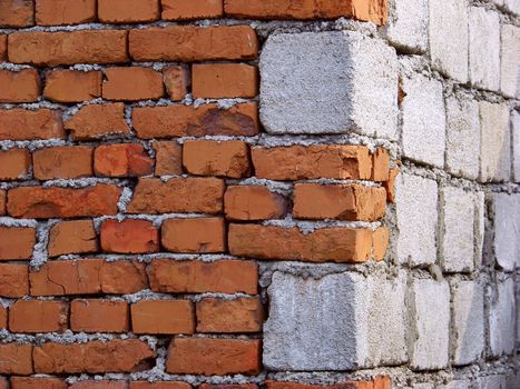 A corner house with stones and bricks