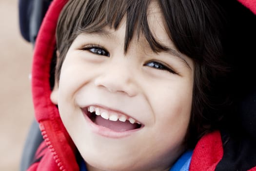 Handsome little three year old  boy smiling, closeup, biracial 