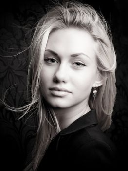 Portrait of a young blond model with sexy look