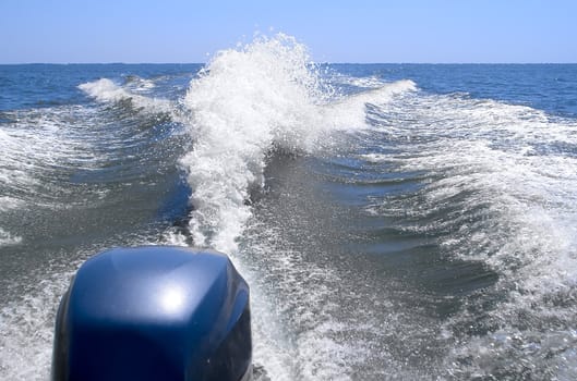 Wave astern boat. Detail of the engine shown   