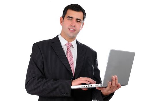 porPortrait of a confident young businessman in a dark suit holding laptop isolated on white