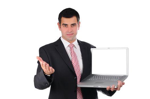 Portrait of a confident young businessman in a dark suit holding laptop and pointing his hand on screen isolated on white