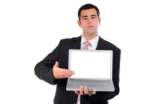 Portrait of a confident young businessman in a dark suit holding laptop and pointing his hand on screen isolated on white