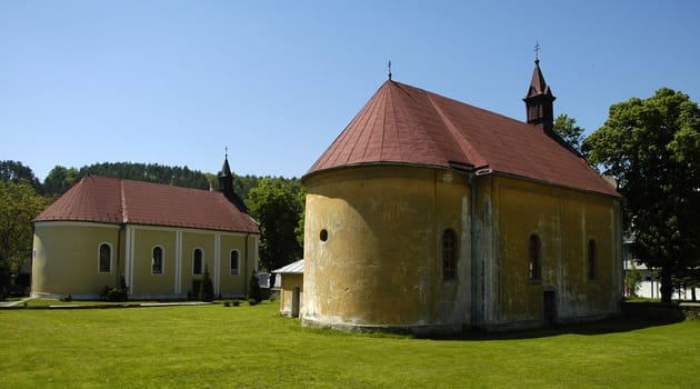 old chapels in Svidnik, Slovakia;
clear blue sky, green grass