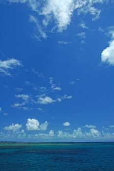 ocean scene, blue sky with white clouds, great barrier reef