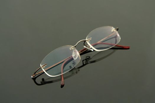 glasses without frame on black reflective background
