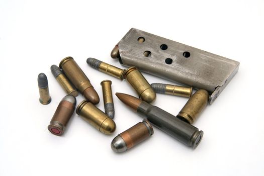 ammunition: several types of bullets and one magazine on white background