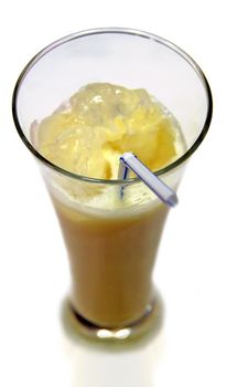 banana coctail in high glass with ice cubes and one straw