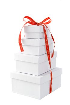 a pile of white presents with a red ribbon on a white background