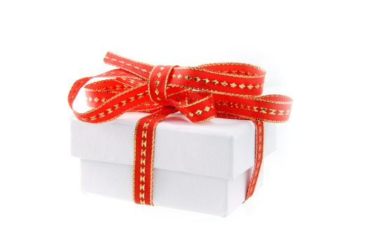 a white present with a red and gold ribbon
