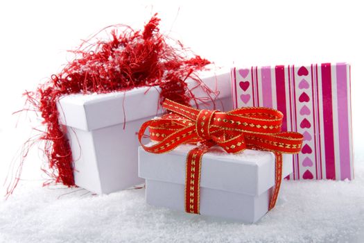 three presents in the snow, on a white background