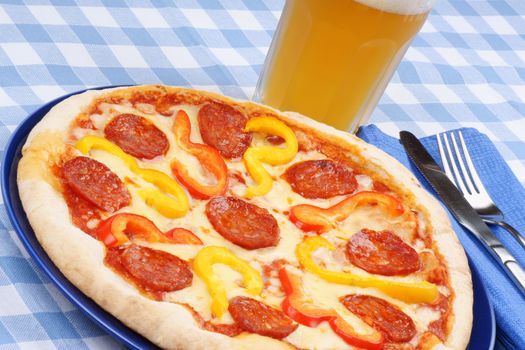 Set table with hot spicy pizza and beer.