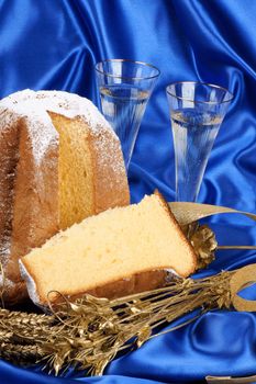 Christmas composition with Pandoro the golden cake of Verona over a blue background.