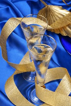 Close-up of two glasses of italian spumante over a blue background.