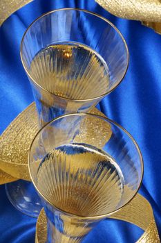 Close-up of two glasses of italian spumante over a blue background.