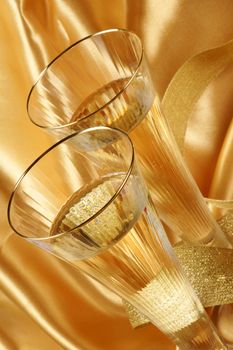 Close-up of two glasses of italian spumante over a yellow background.