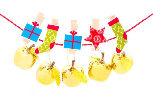 Christmas decorations - golden apples hanging in a row