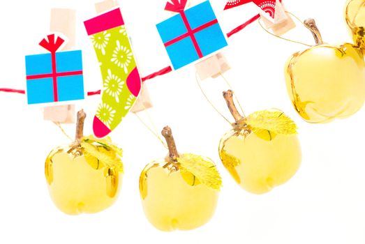 Christmas decorations - golden apples hanging in a row