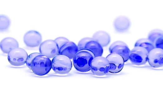 Transparent blue capsules isolated on white