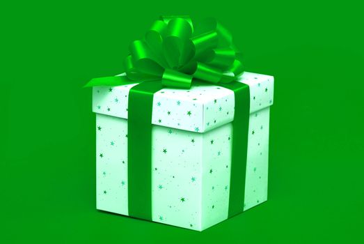 Christmas gift with green ribbon isolated on green background
