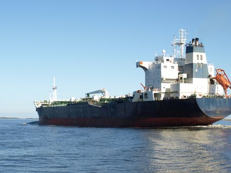A large cargo ship heading out to sea