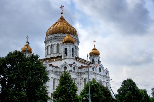 Golden domes against a light glue morning sky.