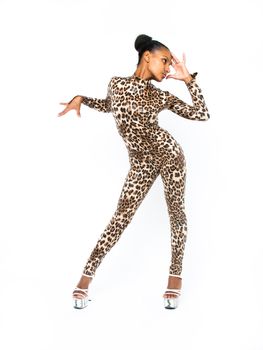 African dancer in a leopard suit striking a dance pose