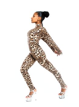 African dancer in a leopard suit striking a dance pose