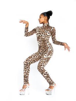 African dancer in a leopard suit striking a dance pose