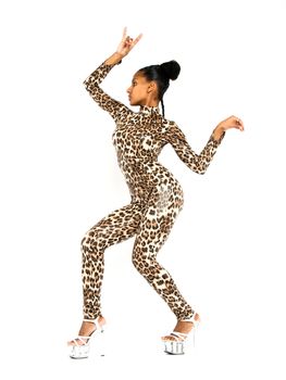 African dancer in leopard suit striking a dance pose