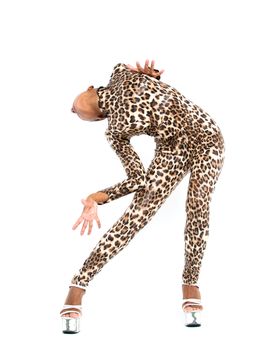 African dancer in leopard suit striking a dance pose