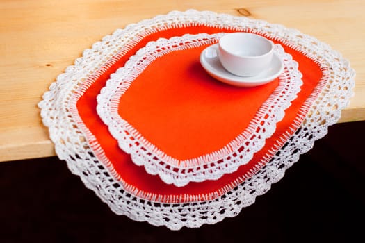 A coffee cup on two orange napkins
