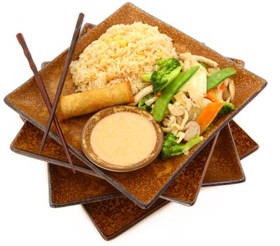 Thai Snow Pea Chicken with snow peas, bamboo slices, napa sauteed mushrooms with rice, spring roll and coconut sauce. In stack of plates over white.