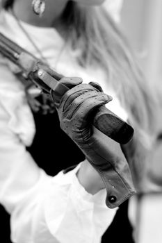 A women handing an old pistol 
