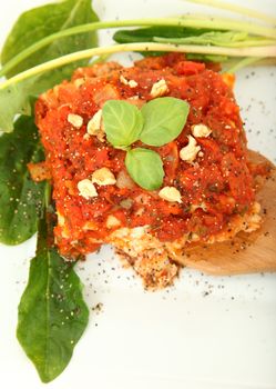 Gorgonzola, Italian blue cheese, with walnuts and basil rolled in lasanga noodles on a bed of spinach.