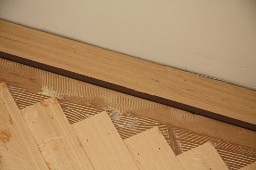 Detail of a parquetry wooden floor in fishbone pattern