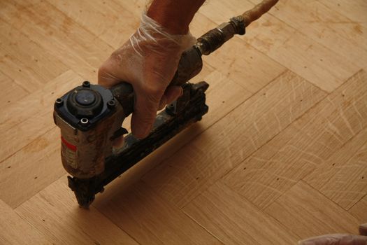 Electric stapler, used for laying a wooden fishbone pattern floor